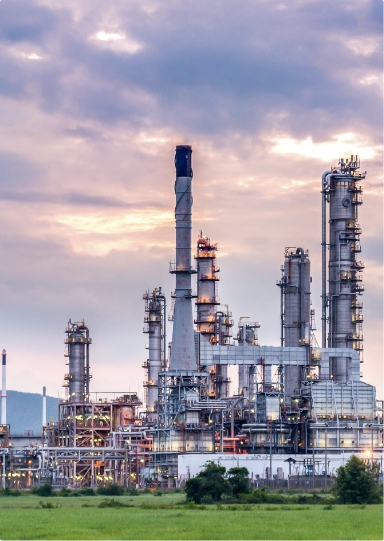 A CCS plant with a cloudy sunset in front of a green field